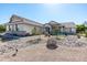 Charming single-story home featuring a desert landscaped front yard, stone accents, and a welcoming facade at 18637 E Flintlock Dr, Queen Creek, AZ 85142