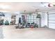 Spacious three car garage featuring bright lighting, painted walls and epoxy floor at 18637 E Flintlock Dr, Queen Creek, AZ 85142