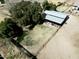 Aerial view of a fenced horse shelter on the property, surrounded by greenery at 18637 E Flintlock Dr, Queen Creek, AZ 85142