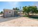 View of a horse shelter with green grass, a secure fence, and ample space for outdoor activities at 18637 E Flintlock Dr, Queen Creek, AZ 85142