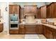 Kitchen featuring built-in stainless oven, dark wood cabinets, and light granite countertops at 18637 E Flintlock Dr, Queen Creek, AZ 85142