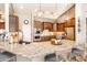 Open concept kitchen with granite countertops, stainless steel appliances, and a large center island at 18637 E Flintlock Dr, Queen Creek, AZ 85142