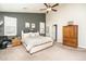 Bright main bedroom featuring a plush bed, ample natural light, and decorative accents at 18637 E Flintlock Dr, Queen Creek, AZ 85142