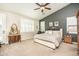 Well-lit main bedroom with a large bed, neutral tones, and stylish furniture at 18637 E Flintlock Dr, Queen Creek, AZ 85142