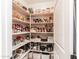 Organized walk-in pantry featuring white shelving and ample storage space for kitchen essentials and appliances at 18637 E Flintlock Dr, Queen Creek, AZ 85142