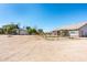 Wide view of an attractive backyard including horse facilities and patio at 18637 E Flintlock Dr, Queen Creek, AZ 85142