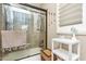 Shower featuring glass doors, neutral tile, and modern finishes at 18637 E Flintlock Dr, Queen Creek, AZ 85142