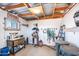 Well-organized storage room with wooden beams, shelving, and ample space for equipment and supplies at 18637 E Flintlock Dr, Queen Creek, AZ 85142