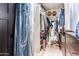 Walk-in closet with custom closet organizers and plenty of storage space for shoes and accessories at 18637 E Flintlock Dr, Queen Creek, AZ 85142