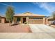 Charming single-story home featuring desert landscaping, a spacious driveway, and a two-car garage at 18648 W Lupine Ave, Goodyear, AZ 85338