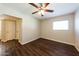Cozy bedroom with a ceiling fan, hard wood floors and a large window at 2027 W Monte Vista Rd, Phoenix, AZ 85009