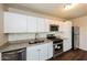 Updated kitchen showcasing stainless steel appliances, white cabinets, and granite countertops at 2027 W Monte Vista Rd, Phoenix, AZ 85009
