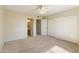 Spacious bedroom with neutral carpet, offering closet space and access to the bathroom at 2104 W Yukon Dr, Phoenix, AZ 85027