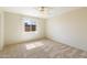 Cozy bedroom with neutral carpet, a window letting in natural light and view of the outdoors at 2104 W Yukon Dr, Phoenix, AZ 85027