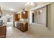 Bright kitchen with tile flooring, wood cabinets, and a view to an outdoor area through a large window at 2104 W Yukon Dr, Phoenix, AZ 85027