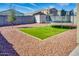 A backyard featuring synthetic grass and desert landscaping and a trampoline at 21407 W Hubbell St, Buckeye, AZ 85396