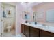 Bright bathroom featuring dual sinks, spacious counter, and tiled floors, offering modern style and functionality at 21407 W Hubbell St, Buckeye, AZ 85396