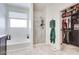 Bright bathroom features a soaking tub, glass shower, and closet, offering a modern design and functionality at 21407 W Hubbell St, Buckeye, AZ 85396
