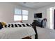 Bedroom featuring a bed, dark dresser and entertainment center, offering a comfortable and functional space at 21407 W Hubbell St, Buckeye, AZ 85396