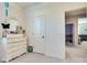 Bedroom with white dresser and decor with door to hallway at 21407 W Hubbell St, Buckeye, AZ 85396