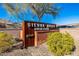The Sienna Hills Swim Club is a community gathering place with beautiful landscaping and a rustic, well-designed sign at 21407 W Hubbell St, Buckeye, AZ 85396