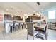 Modern dining room with seating for four, stainless steel appliances, and elegant lighting, ideal for Gathering meals at 21407 W Hubbell St, Buckeye, AZ 85396