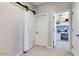 Bright hallway showcasing a sliding barn door and an entrance to a bedroom, offering modern style and functionality at 21407 W Hubbell St, Buckeye, AZ 85396