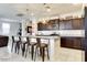 Well-designed kitchen with dark cabinets, stainless steel appliances, and bar-style seating, offering a modern and functional space at 21407 W Hubbell St, Buckeye, AZ 85396