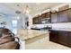 Beautiful kitchen features dark wood cabinets, stainless steel appliances, granite countertops, and bar seating at 21407 W Hubbell St, Buckeye, AZ 85396