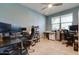 Spacious home office featuring multiple desks and ample workspace for productivity at 21407 W Hubbell St, Buckeye, AZ 85396