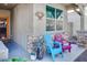 Inviting covered porch with colorful Adirondack chairs, creating a cozy and welcoming outdoor seating area at 21407 W Hubbell St, Buckeye, AZ 85396