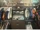 The walk-in closet is equipped with shelves and hanging space for clothing and personal items at 21407 W Hubbell St, Buckeye, AZ 85396