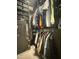 This large walk-in closet has custom shelving, drawers, and hanging rods for clothes and a safe at 21407 W Hubbell St, Buckeye, AZ 85396