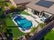 The aerial view showcases a luxurious backyard pool, manicured landscaping, and an inviting patio area at 21857 N Gibson Dr, Maricopa, AZ 85139