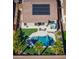 Aerial view of backyard featuring pool, spa, patio area, solar panels, and low-maintenance landscaping at 21857 N Gibson Dr, Maricopa, AZ 85139