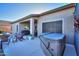 Spacious backyard with a hot tub, patio seating, and well-maintained landscaping at 21857 N Gibson Dr, Maricopa, AZ 85139