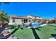 The backyard features a pool, hot tub, seating, and solar panels for sustainable energy at 21857 N Gibson Dr, Maricopa, AZ 85139