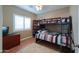 Bedroom featuring bunk beds with a striped comforter, window with shutters, and a dresser at 21857 N Gibson Dr, Maricopa, AZ 85139
