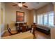 Bright dining room with a glass-top table, wooden chairs, and shuttered windows providing natural light and a cozy atmosphere at 21857 N Gibson Dr, Maricopa, AZ 85139