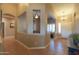 Welcoming foyer with neutral walls, tile flooring, and open archways leading to the dining room and other living spaces at 21857 N Gibson Dr, Maricopa, AZ 85139