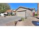 Attractive single-story home with desert landscaping and a two-car garage in a suburban setting at 21857 N Gibson Dr, Maricopa, AZ 85139