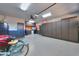 Functional garage with ceiling fan, storage cabinets, work bench, and epoxy floor at 21857 N Gibson Dr, Maricopa, AZ 85139