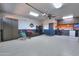 Functional garage with ceiling fan, storage cabinets, work bench, and epoxy floor at 21857 N Gibson Dr, Maricopa, AZ 85139