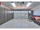 Spacious garage featuring built-in cabinets, ceiling fan, and epoxy floor at 21857 N Gibson Dr, Maricopa, AZ 85139