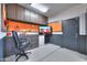 Functional garage featuring built-in storage cabinets, a workbench, and epoxy floors at 21857 N Gibson Dr, Maricopa, AZ 85139
