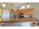 Bright kitchen featuring stainless steel appliances, a tile backsplash, and an island countertop at 21857 N Gibson Dr, Maricopa, AZ 85139