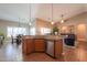 Open kitchen area featuring stainless steel appliances and seamless flow to dining and living spaces at 21857 N Gibson Dr, Maricopa, AZ 85139