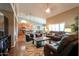 Spacious living room with hardwood floors, a comfortable leather sofa set, and an open layout connecting to the kitchen at 21857 N Gibson Dr, Maricopa, AZ 85139