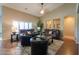 Spacious living room featuring vaulted ceilings, a comfortable leather sofa set, and an open layout connecting to other areas at 21857 N Gibson Dr, Maricopa, AZ 85139