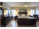 Spacious main bedroom with light hardwood floors, shuttered windows, and neutral wall coloring at 21857 N Gibson Dr, Maricopa, AZ 85139